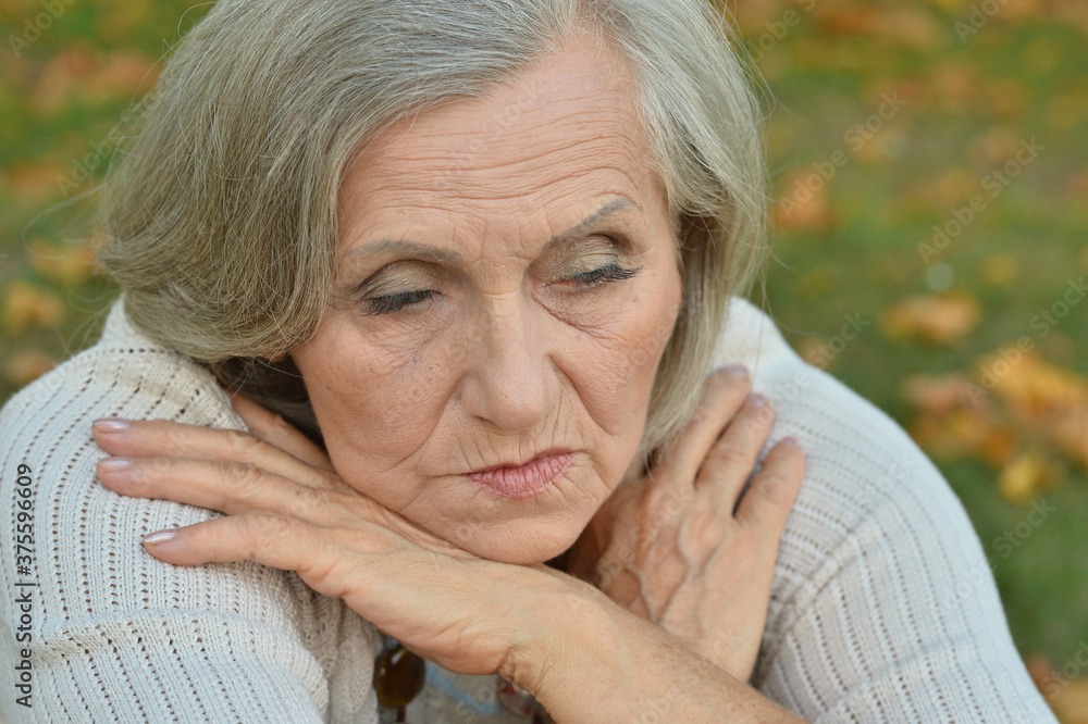 Portrait of sad, thoughtful senior woman in park Portrait of sad, thoughtful senior woman in park
