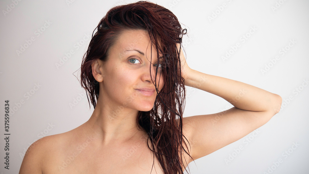 Portrait of a Caucasian woman with wet hair on a white background. Portrait of a Caucasian woman with wet hair on a white background.