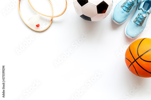 Sport games background - basketball, soccer ball, rackets, sneakers. Copy space