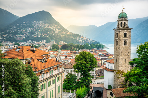 Scenic cityscape of Lugano with Cathedral of Saint Lawrence bell tower and lake view and dramatic light in Lugano Switzerland photo
