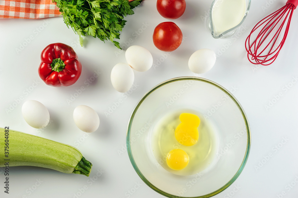 Top view of Healthy food background with various vegetables ingredients, eggs tomatoes milk on white background. Cuisine and kitchen concept. Top view of Healthy food background with various vegetables ingredients, eggs tomatoes milk on white background. Cuisine and kitchen concept.