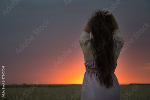 young woman watching the sunset