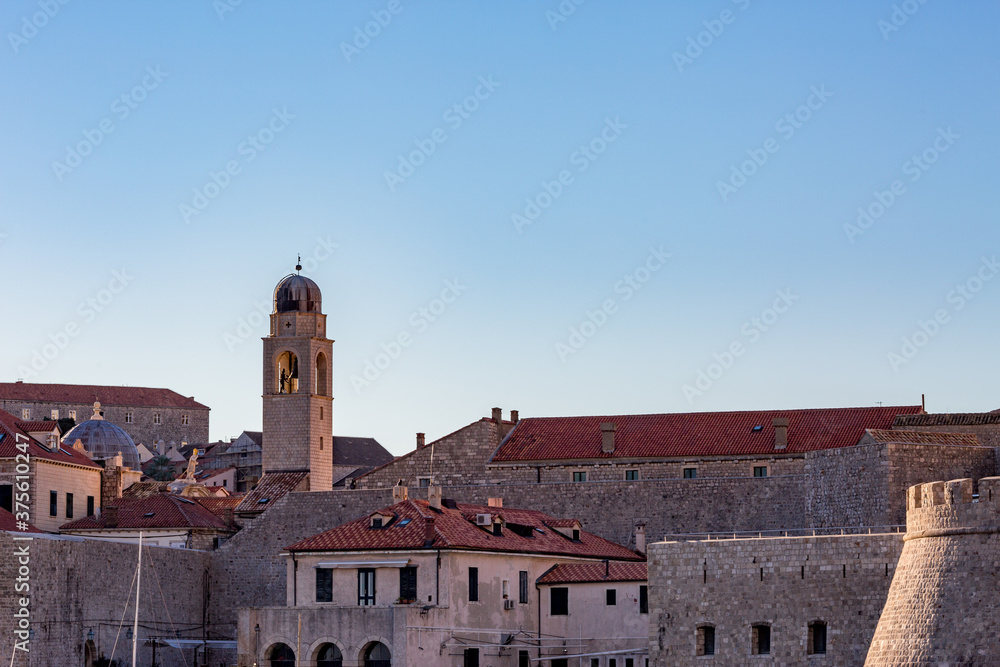 Detailed view with churches from outside, clear blue-sky sunny day. Scenery winter view of Mediterranean old city of Dubrovnik, famous European travel and historic destination, Croatia