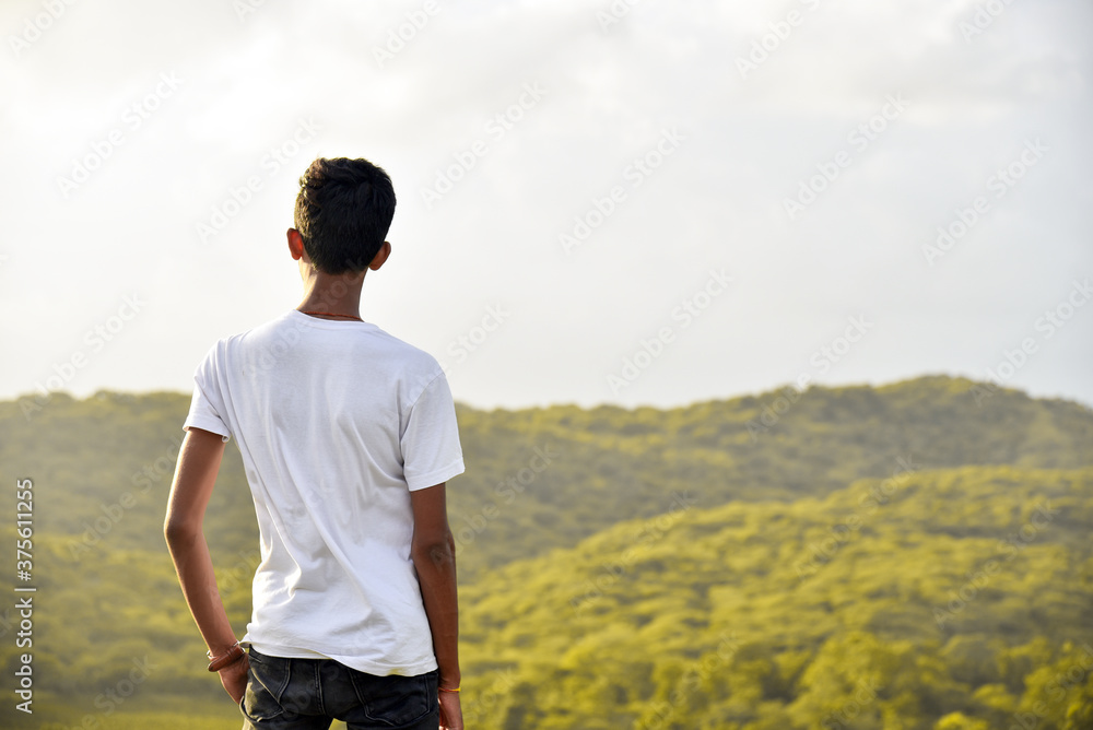 man standing on a hill