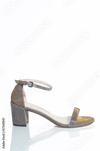 Elegant middle heel female shimmering shoes isolated on a white background.