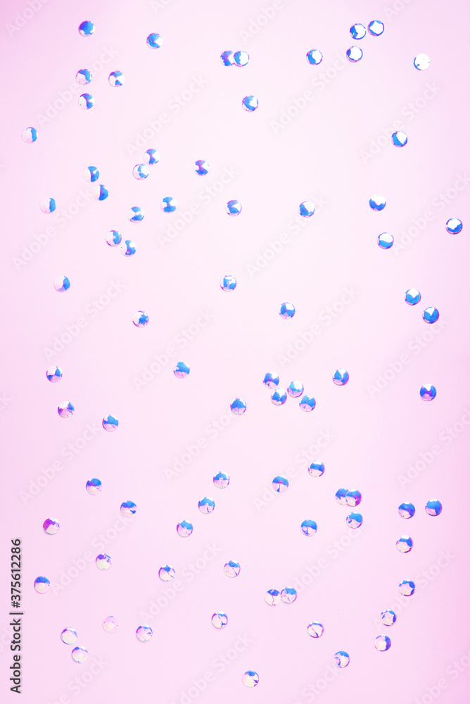 Colorful confetti on pink background. Happy new year celebration party. Greetings and congratulation concept. Festive backdrop with copy space for your design