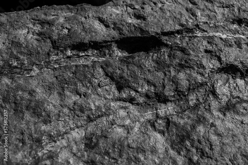 Closeup on rock rough natural mineral stone background, top view.