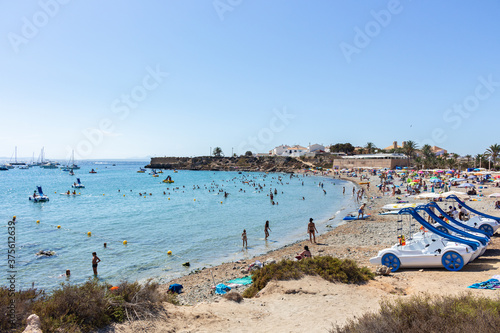 View of the beach in Tabarca Island. A lot of people are enjoying beautiful blue mediterranean sea in a sunny day