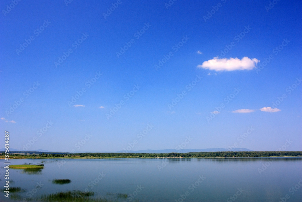 Calm blue surface of a lake under a blue sky