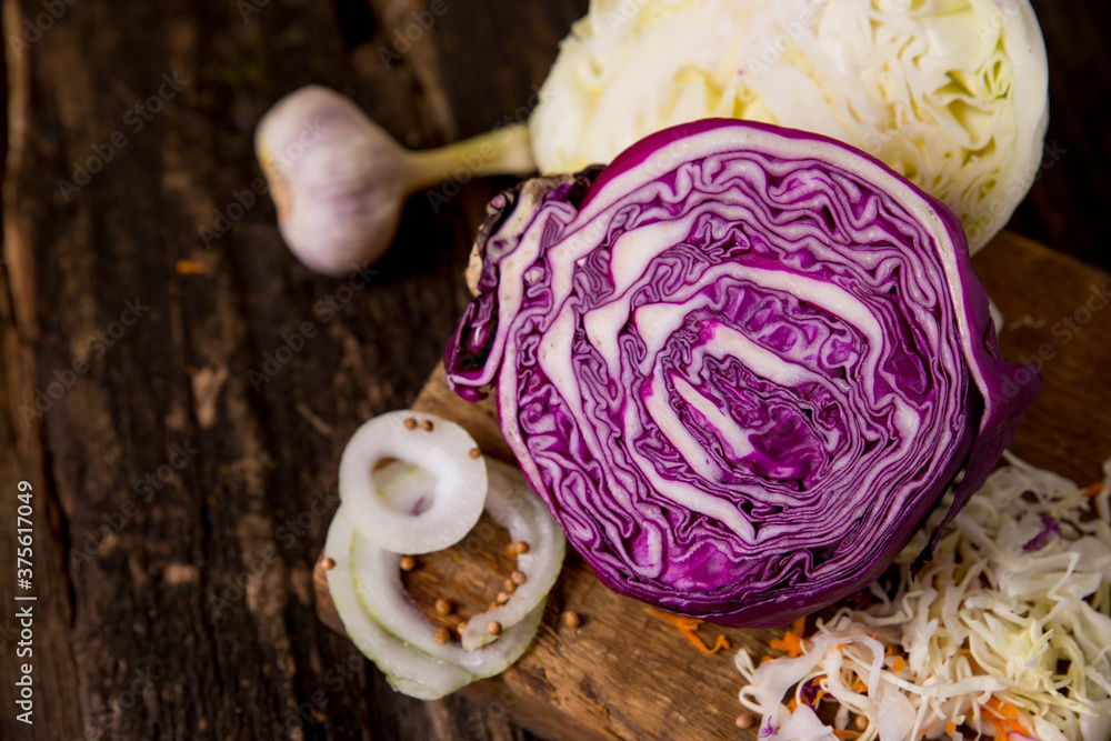 Fototapeta premium red cabbage, green cabbage, onions, garlic, grated carrots. Vegetable ingredients on the table, place for text, copy space. Background image