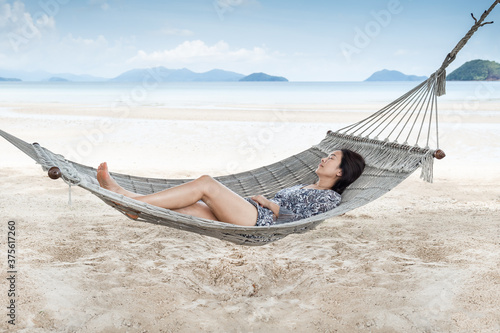 Beautiful woman sleeping on hammock on the beach, Moment from the vocation.