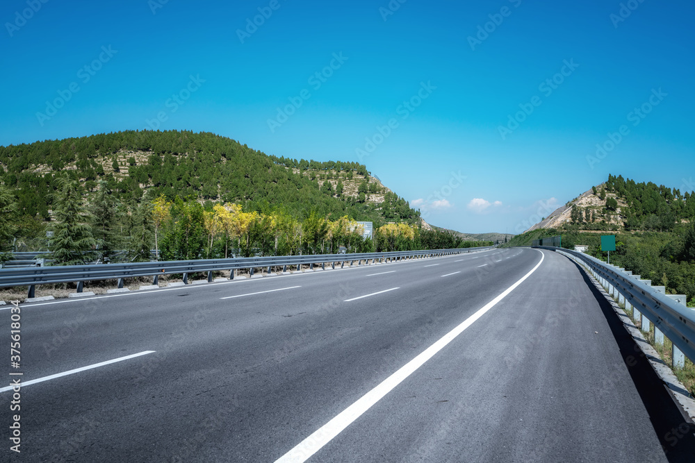 Asphalt highways and mountains under the blue sky Asphalt highways and mountains under the blue sky