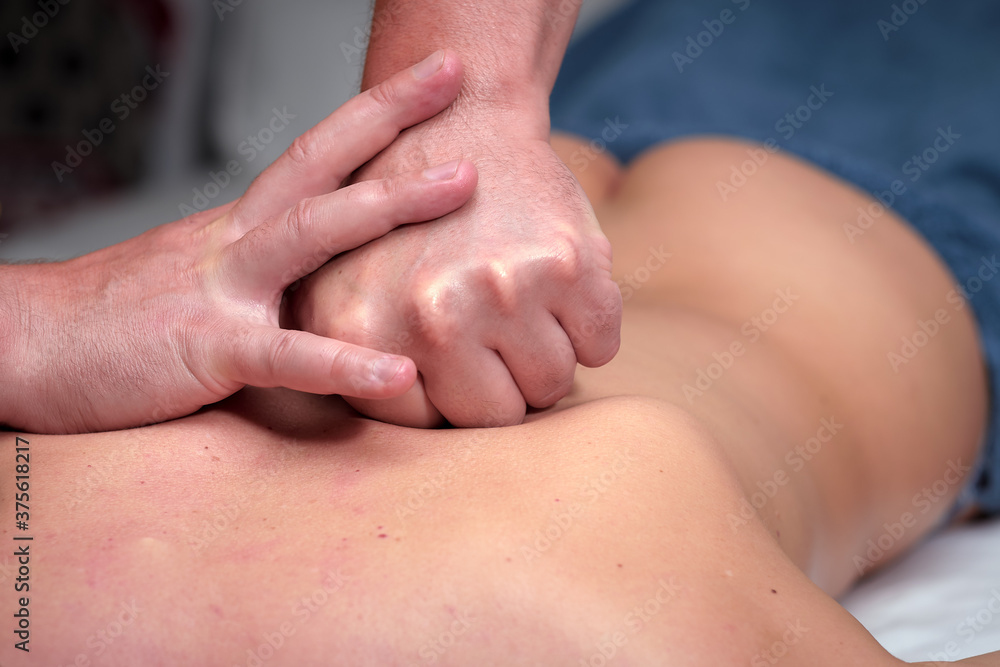 massage therapist, hands of the masseur - general relaxing massage of the back muscles massage therapist, hands of the masseur - general relaxing massage of the back muscles
