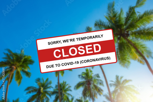 Tropical resort beach closed due to Coronavirus Covid-19 sign