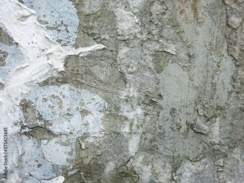 dirty rough concrete surface with scratches and scraps of ads, brutal and harsh background