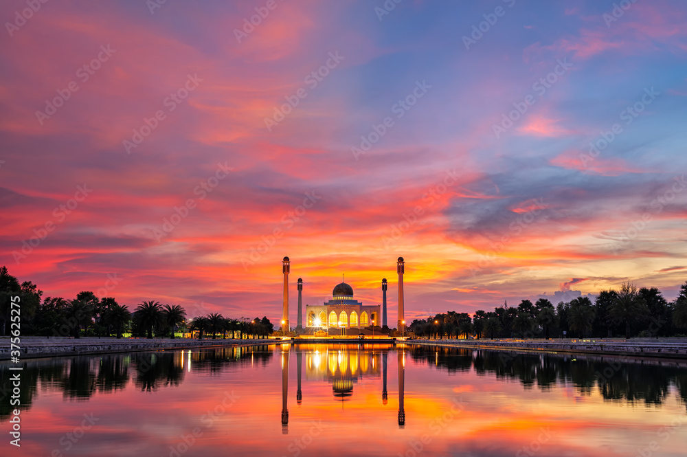 Songkhla Central Mosque in day to night with colorful skies at sunset and the lights of the mosque and reflections in the water in landmark landscape concept. Songkhla Central Mosque in day to night with colorful skies at sunset and the lights of the mosque and reflections in the water in landmark landscape concept.