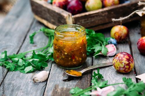 Tkemali plum sauce in a jar. Georgian sauce photo