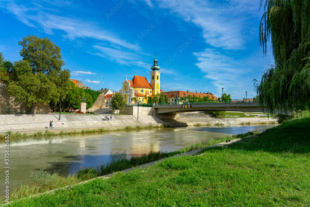 Gyor city with the Raba river and a carmelite church in Hungary