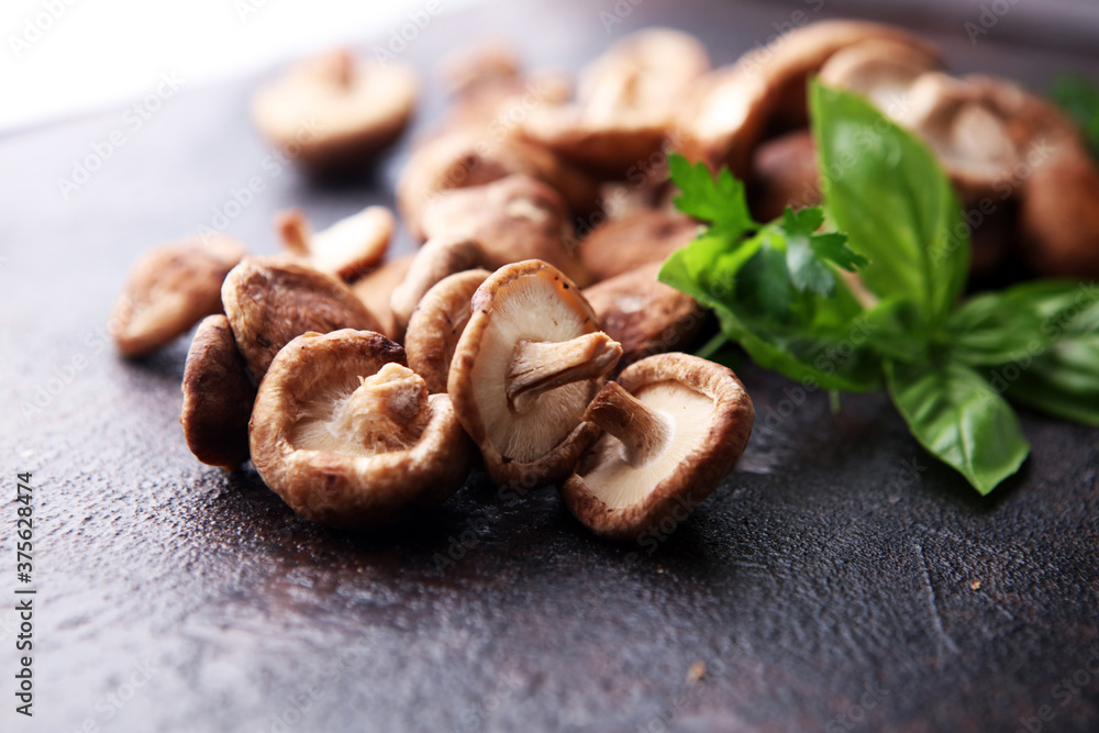 Raw wild shiitake mushrooms. Composition with wild mushrooms Raw wild shiitake mushrooms. Composition with wild mushrooms