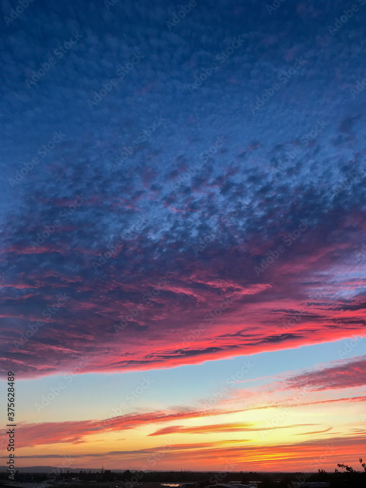 Dramatic colorful pink cloud formation at sunset