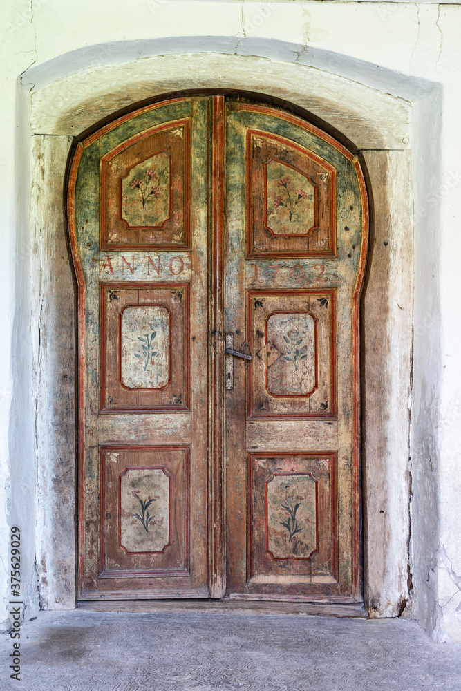 Old vintage door with painted flowers motifs from 1792.