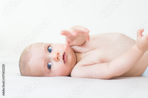 Cute baby girl lying on bed