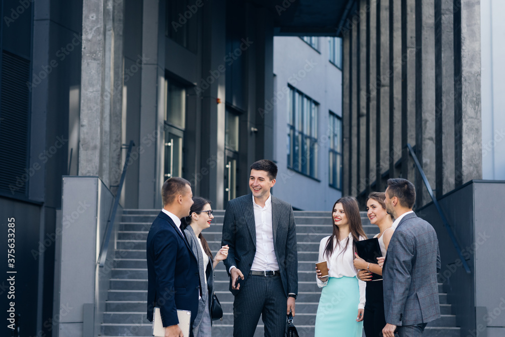 Obraz premium Businessman in suit talking to business people colleagues or partner. Male leader discussing work at team meeting or group negotiations having conversation.