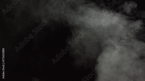 Soft Fog in Slow Motion on Dark Backdrop. Realistic Atmospheric Gray Smoke on Black Background. White Fume Slowly Floating Rises Up. Abstract Haze Cloud. Animation Mist Effect. Smoke Stream Effect 4K