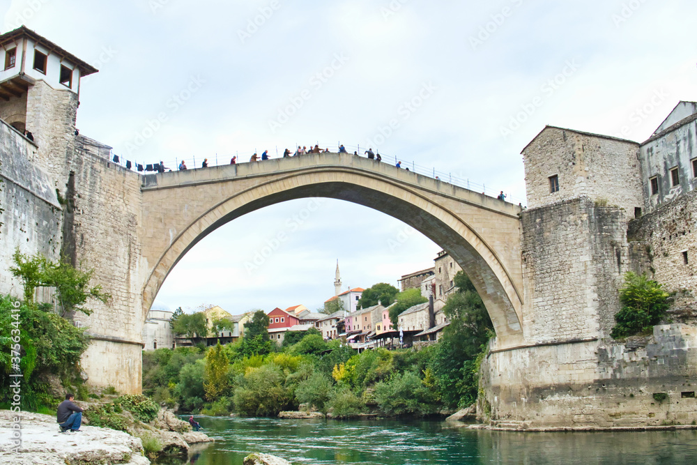 The historic town of Mostar, spanning a deep valley of the Neretva River, is famous for Old Bridge, Stari Most. The Ottoman architecture is protected by UNESCO