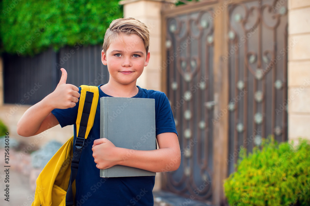 Pupil with book and backpack outdoor. Back to school Pupil with book and backpack outdoor. Back to school