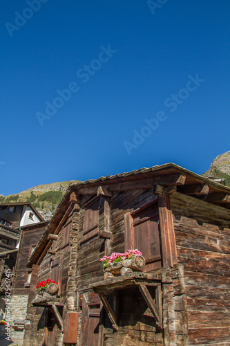 Traditional wooden buildings of Valais canton, Switzerland, at Zermatt (summer, blue sky)