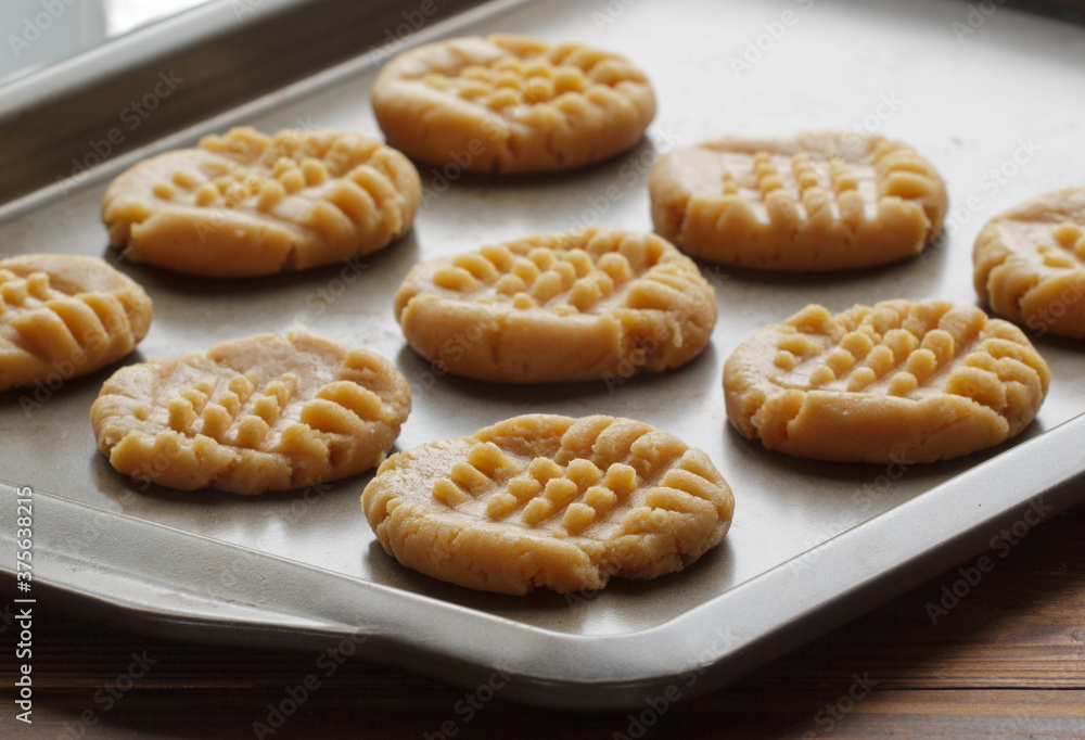 Peanut butter cookie dough on baking sheet in natural kitchen light. Peanut butter cookie dough on baking sheet in natural kitchen light.