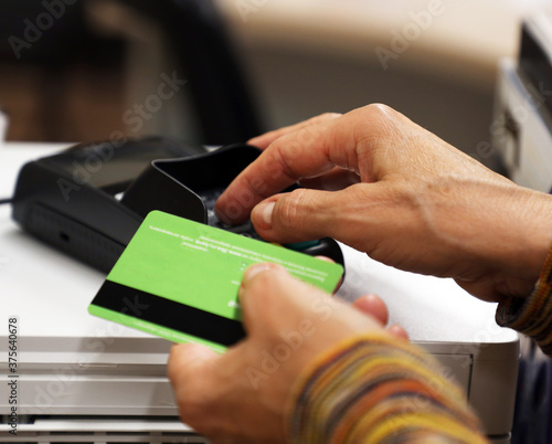 female hands holding a bank card  payment in a mobile terminal