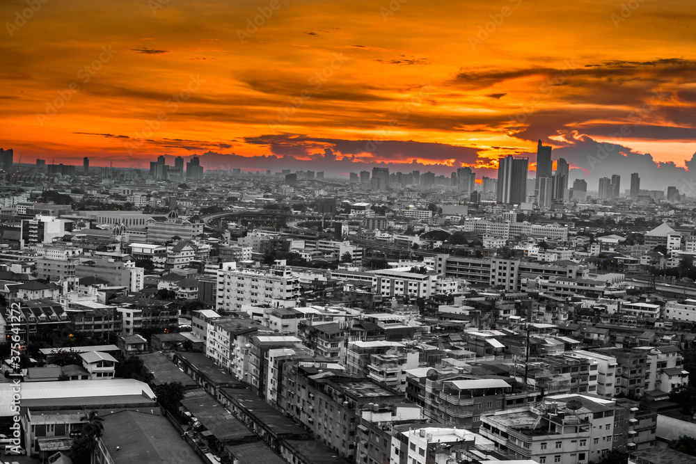 Fototapeta premium The high angle background of the city view with the secret light of the evening, blurring of night lights, showing the distribution of condominiums, dense homes in the capital community