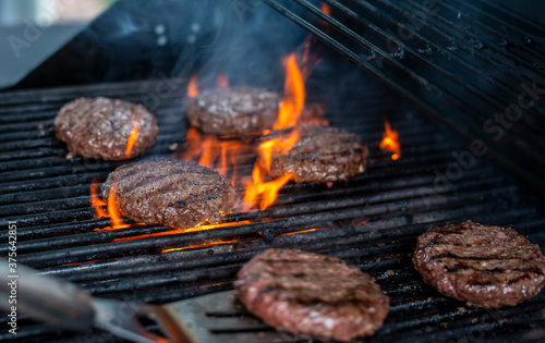 Hamburger on Grill being Flipped