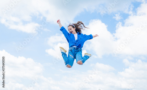 free your imagination. kid beauty and fashion. child jump in casual style. Child jumping on background of sky. summer holiday concept. childhood happiness. happy childrens day. Beautiful female