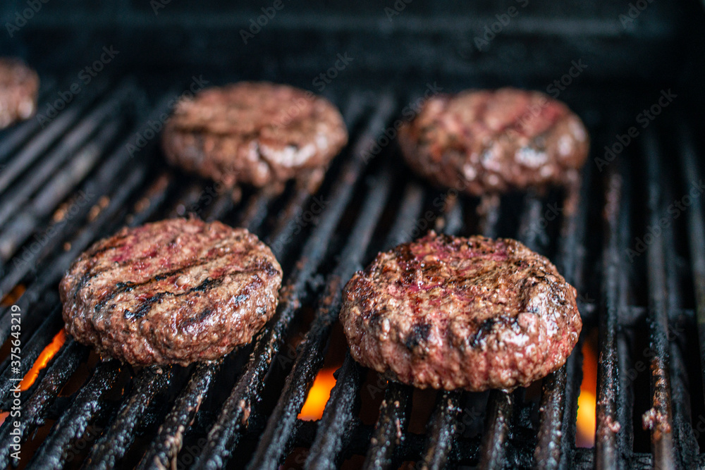 Hamburger on Grill Close Up Hamburger on Grill Close Up