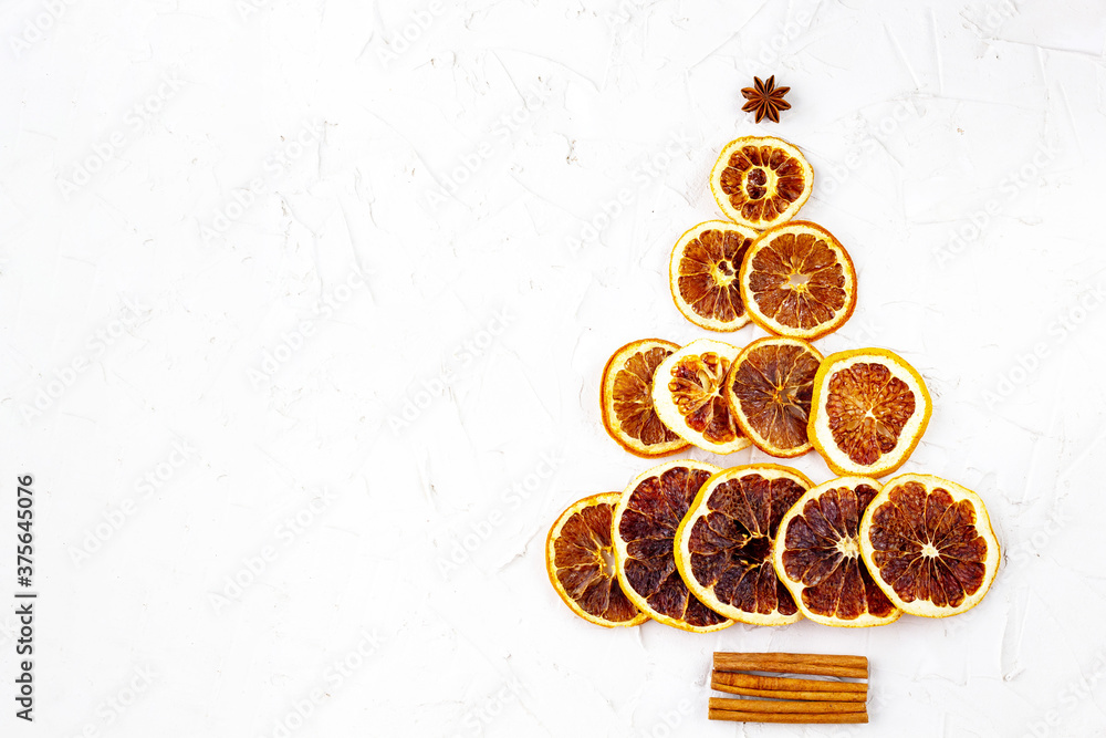 Christmas tree made of dried citruses and cinnamon on white background. Christmas tree made of dried citruses and cinnamon on white background.