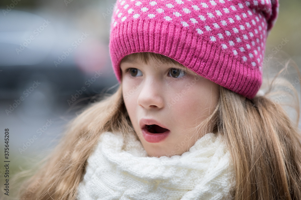 Pretty child girl in warm knitted winter clothes outdoors. Pretty child girl in warm knitted winter clothes outdoors.