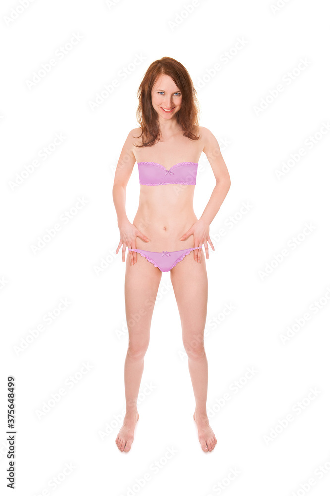 Beautiful cheerful woman wearing pink bra and panties, portrait isolated in front of white studio background Beautiful cheerful woman wearing pink bra and panties, portrait isolated in front of white studio background