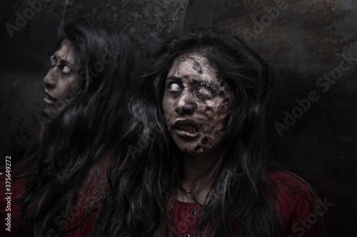 woman with long hair disguised as a zombie, reflecting in a mirror, with dark background, horror 