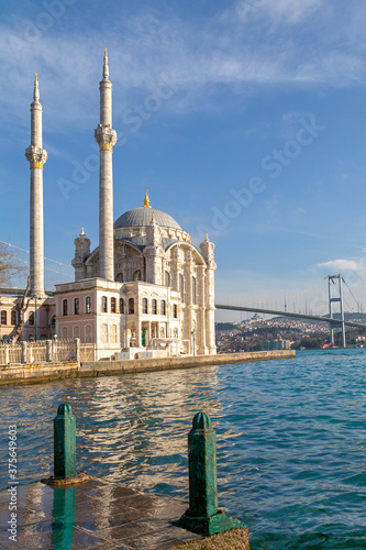 Ortakoy Mosque known also as Mecidiye Mosque, with Bosphorus Bridge connecting Europe to Asia, in the background, in Istanbul, Turkey photo