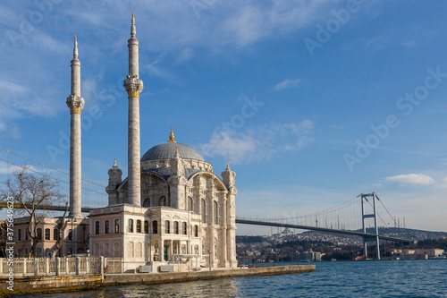 Ortakoy Mosque known also as Mecidiye Mosque, with Bosphorus Bridge connecting Europe to Asia, in the background, in Istanbul, Turkey