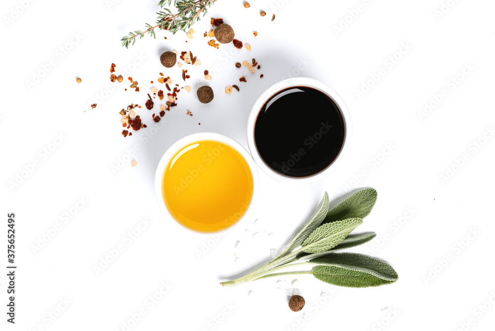Various spices, herbs, olive oil and balsamic vinegar on a white background top view. Free space for text. Food background, ingredients for cooking. - obrazy, fototapety, plakaty 