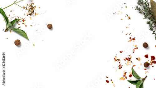 Various spices and herbs on a white background top view. Free space for text. Food background, ingredients for cooking.
