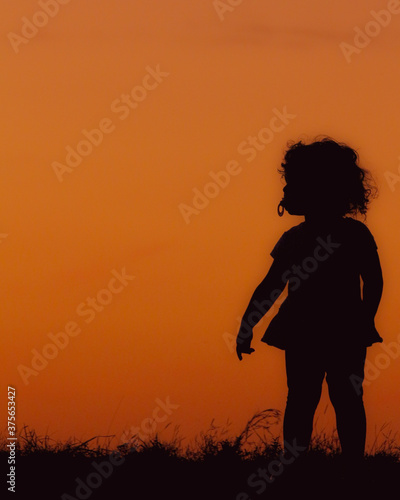 Families and children in the shadow and siloette of the sunset