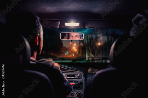 man inside the car, strolling through the city. Taxi taking a ride. bright lights to the city. © Ricardo