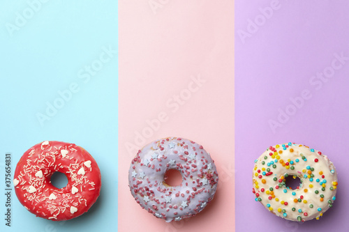 Tasty donuts on three tone background, top view