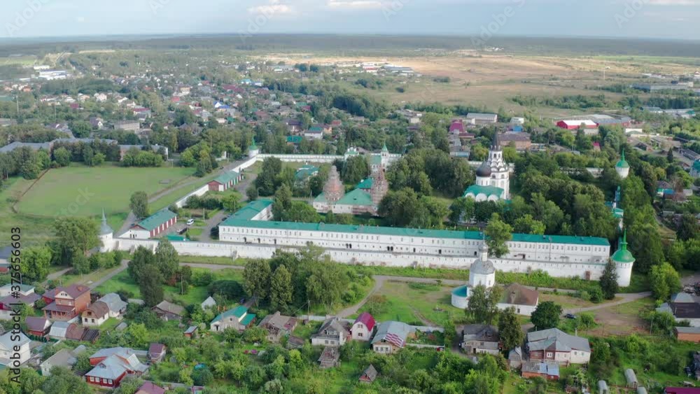 Scenic cinematic aerial view of the Cathedral of St. Trinity and the hip-roof bell-tower of the Crucifixion in center of Alexandrova Sloboda in Alexandrov in Russian Federation Scenic cinematic aerial view of the Cathedral of St. Trinity and the hip-roof bell-tower of the Crucifixion in center of Alexandrova Sloboda in Alexandrov in Russian Federation