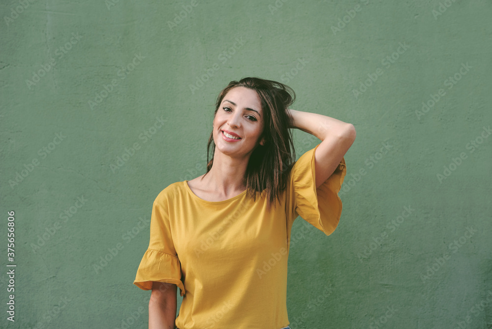 smiling young woman over green background